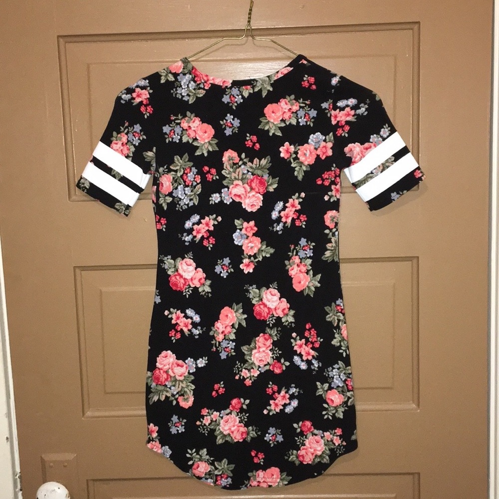 Black velvet dress with white words, and flowers.